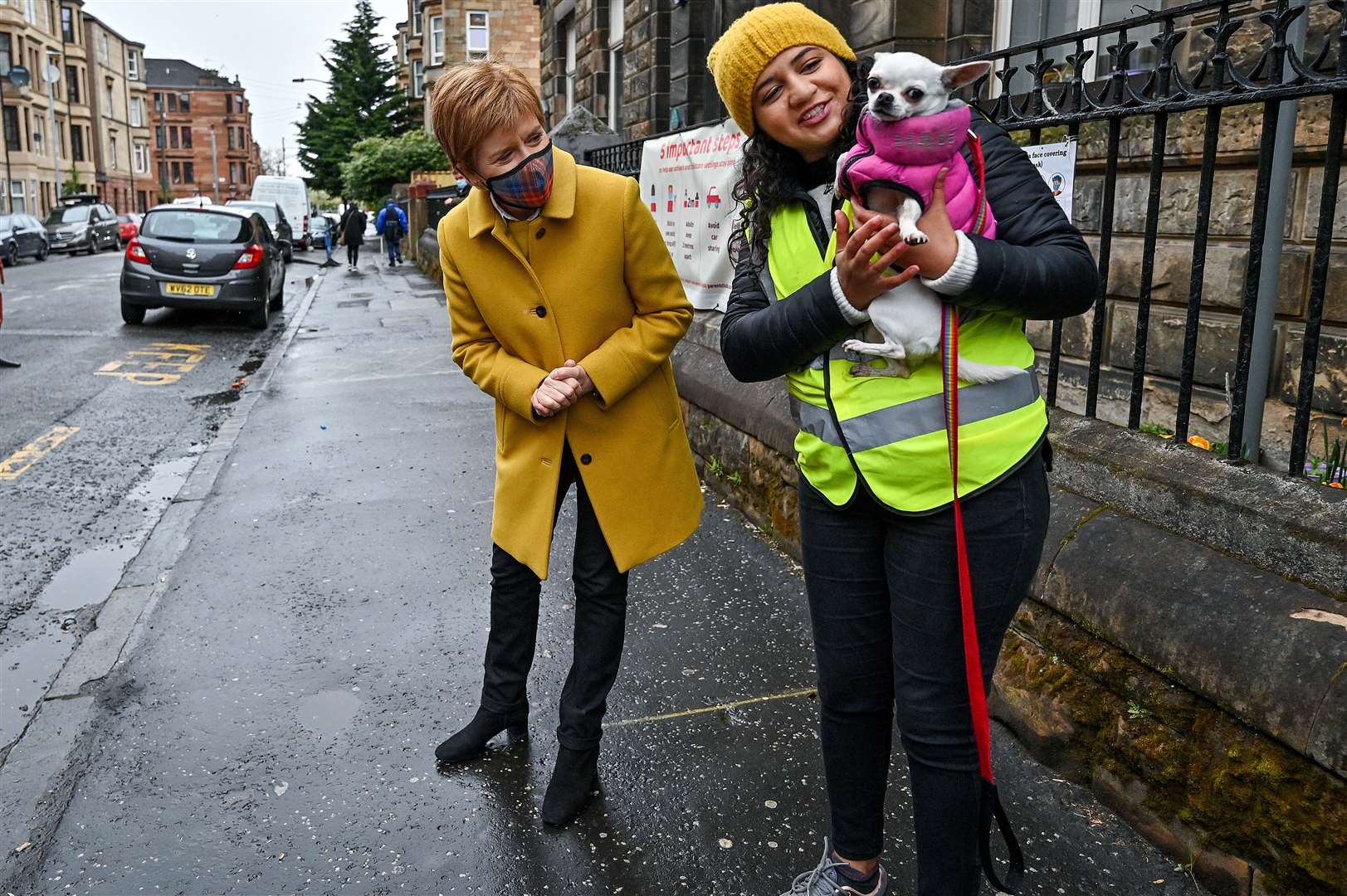 Nicola Sturgeon and Roza Salih had photos taken with a dog outside the polling station (Jeff J Mitchell/PA)