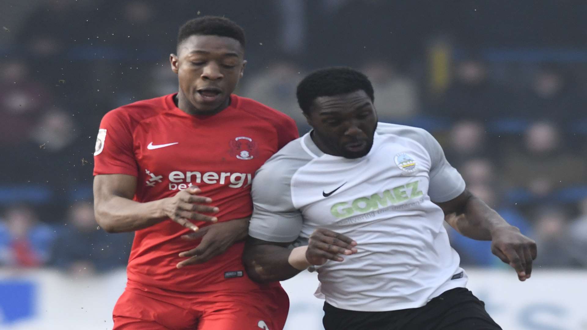 Ebou Adams goes shoulder to shoulder with Dover's Femi Ilesanmi Picture: Tony Flashman