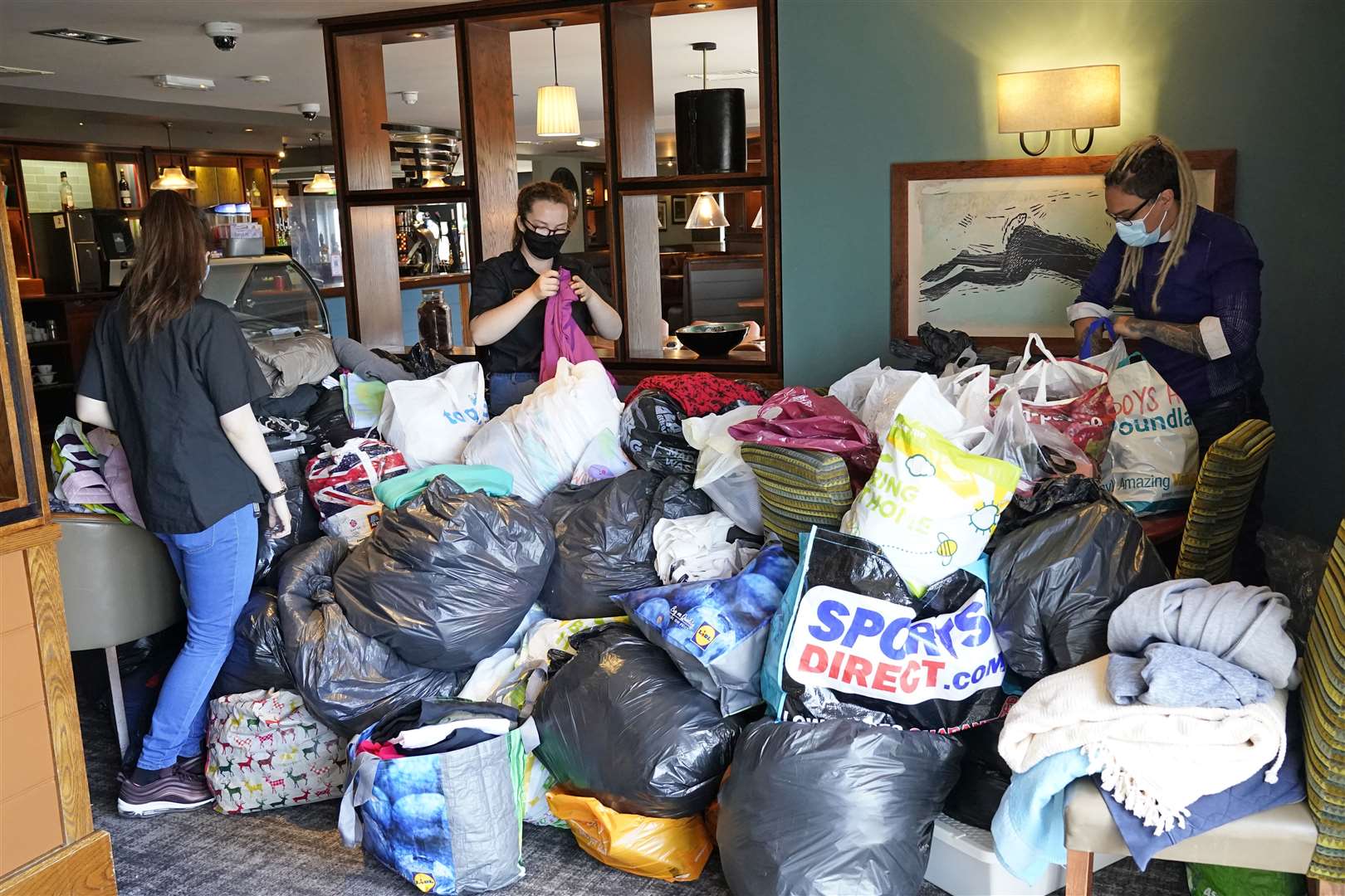 Staff arrange donations at the Hurley Flyer pub in Morecambe (Danny Lawson/PA)