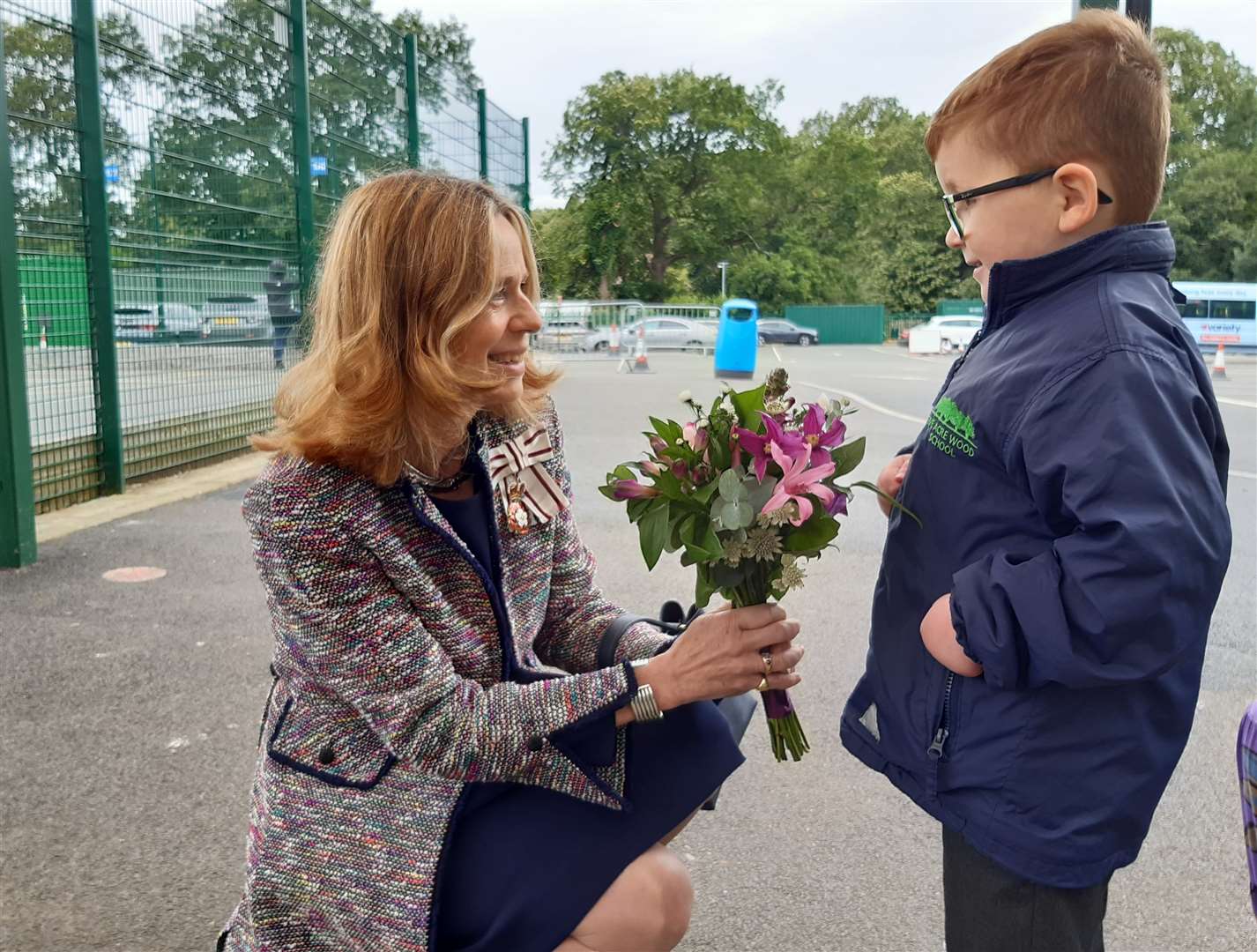 Five Acre Wood student Finley Parrin presents flowers to the Lord Lieutenant of Kent, Lady Colgrain, who officially opened the pool