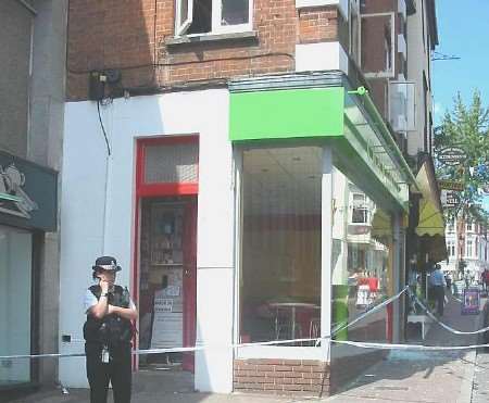 Police outside the fire-damaged property. Picture: LEE WINTER