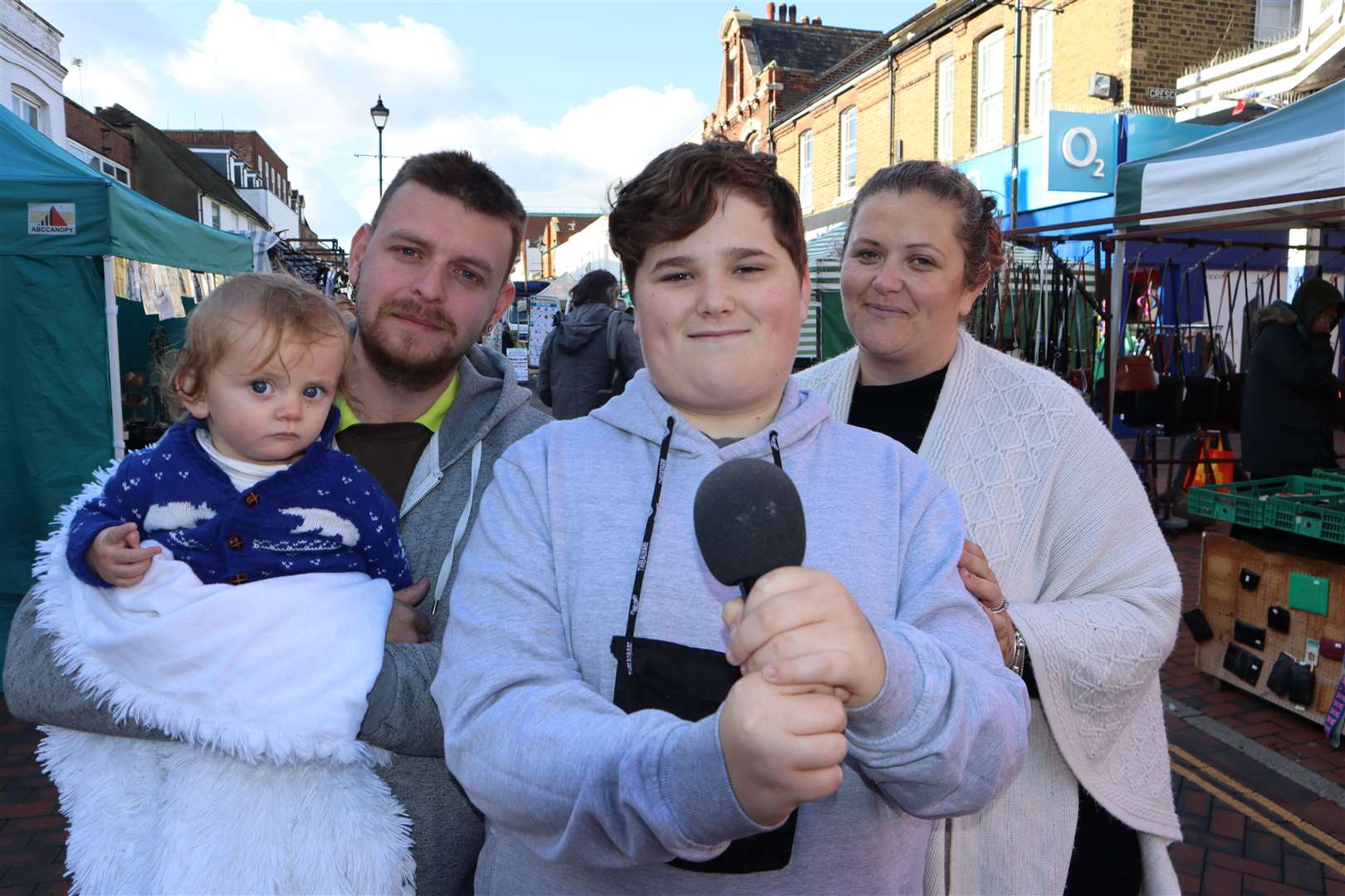 Busker Tyler Watts, 13, with his mum Sadie, dad Kieran and baby brother Oaklee-Rae in Sittingbourne High Street. Picture: John Nurden