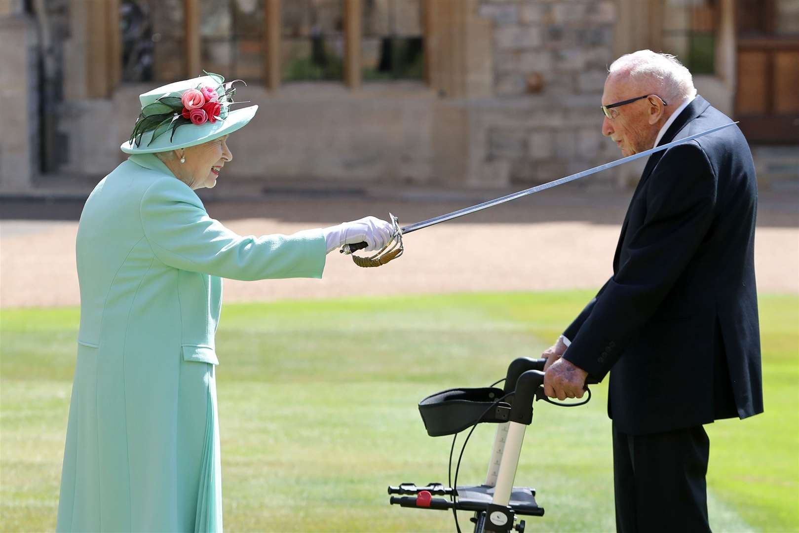 Captain Sir Thomas Moore receives his knighthood from the Queen during a ceremony at Windsor Castle (Chris Jackson/PA Images)