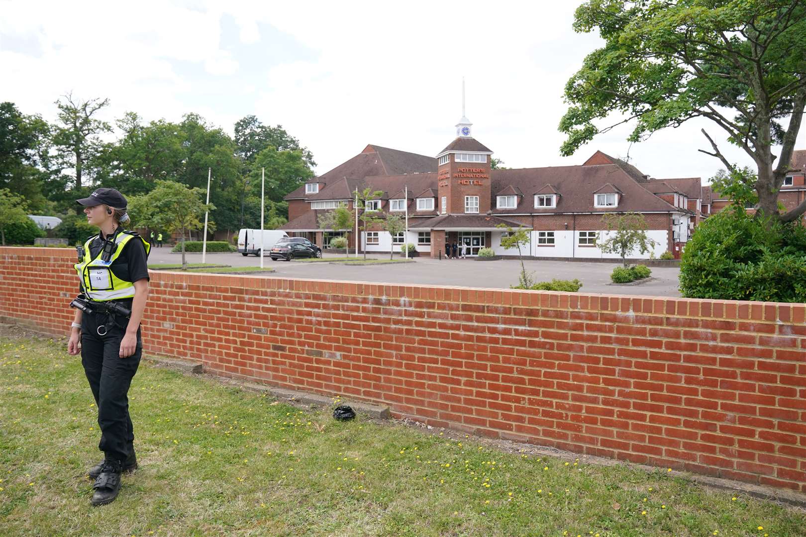 Police officers outside the Potters International Hotel in Aldershot (Jonathan Brady/PA)