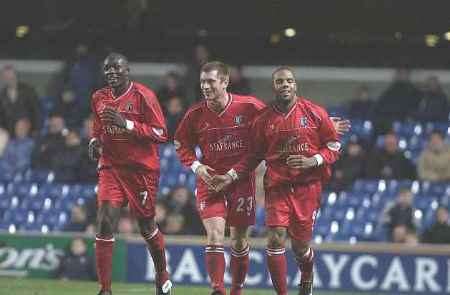 CONSOLATION: Marlon King, right, celebrates his last-minute goal with Tommy Johnson and Nyron Nosworthy. Picture: MATTHEW WALKER