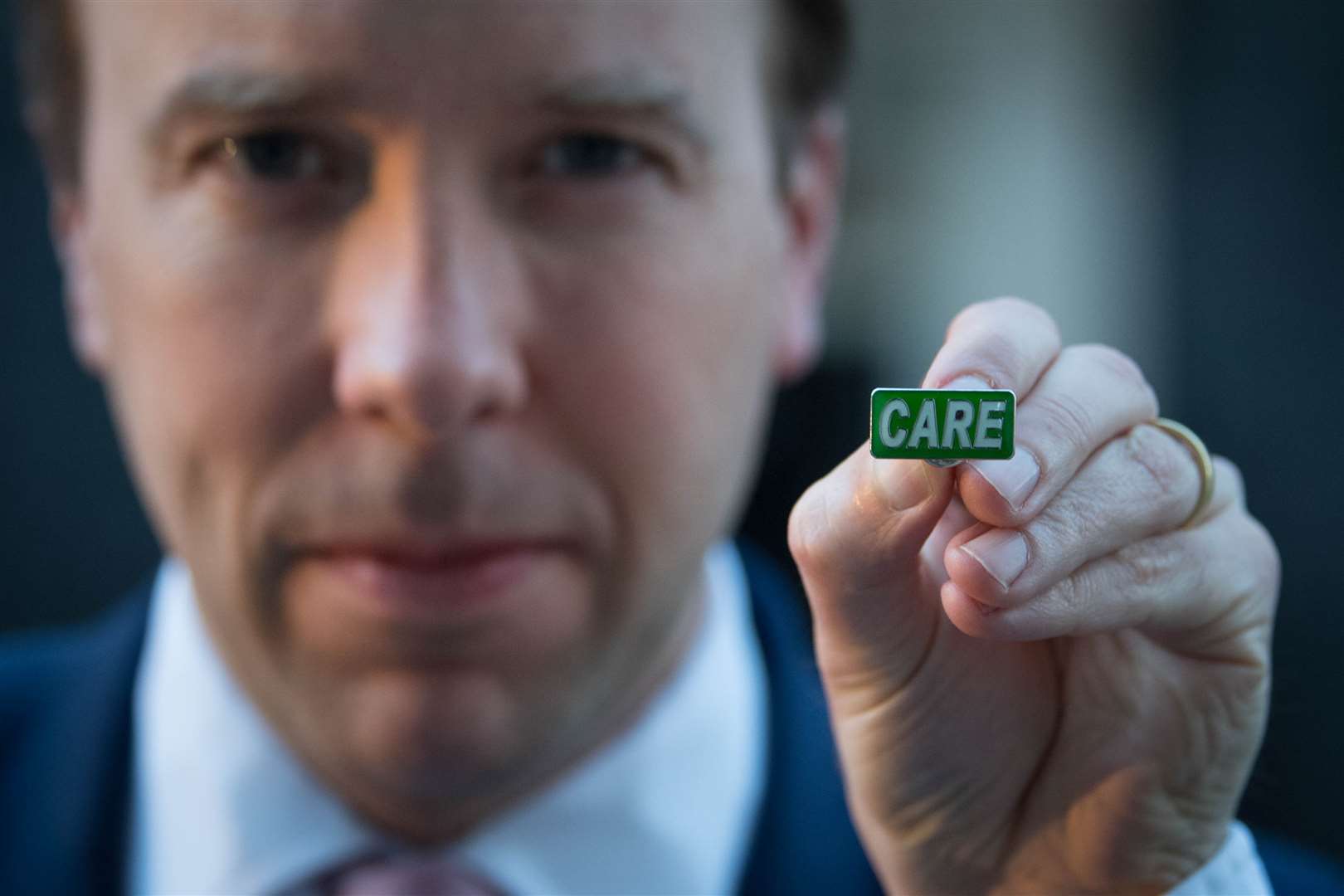 Health Secretary Matt Hancock showing the new ‘Care’ badge (Stefan Rousseau/PA)