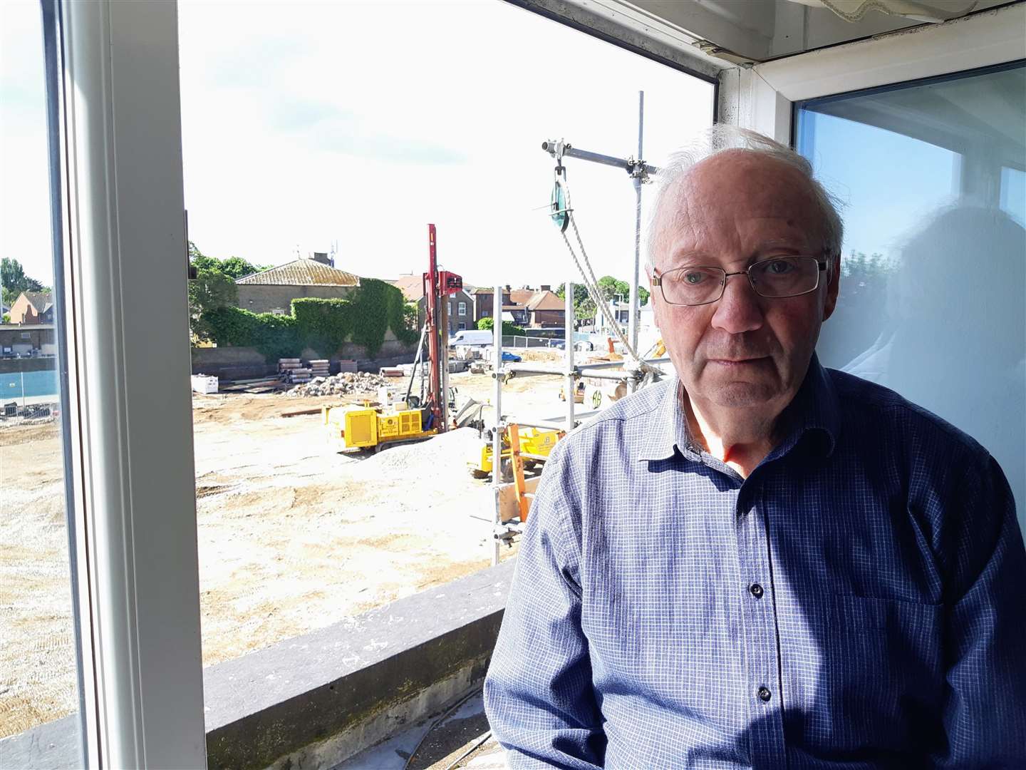 Tony Scarfe, pictured by his upstairs window, say the vibrations feel like an earthquake