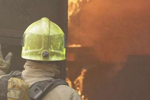 Firefighter tackling a blaze. Stock photo.