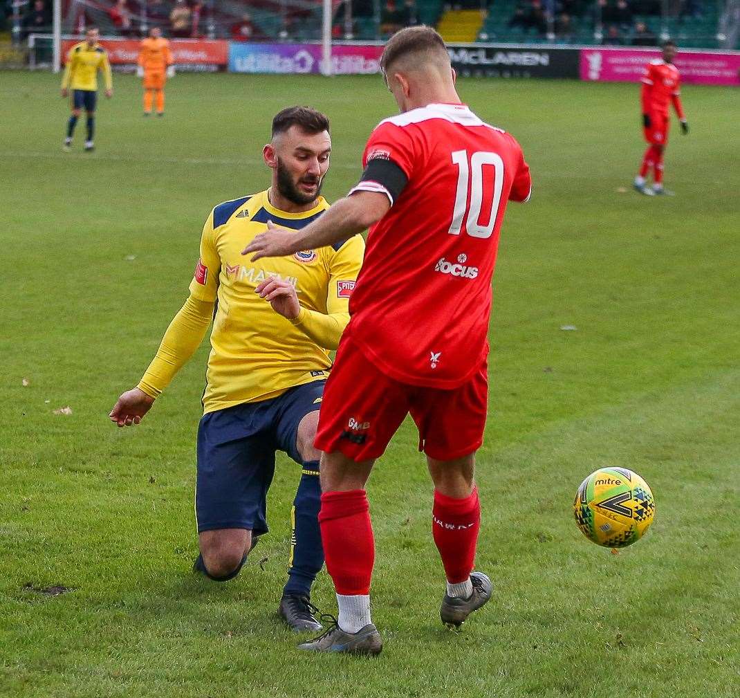 James Brown tangles with Whitehawk captain Henry Muggeridge. Picture: Les Biggs