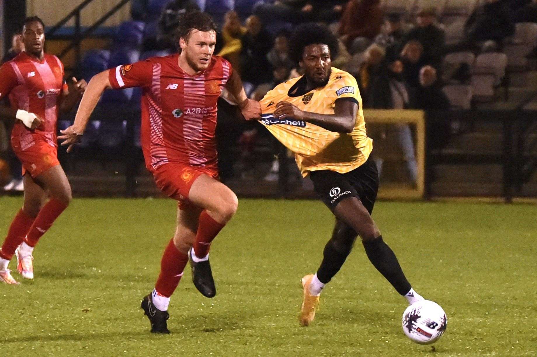 Devonte Aransibia is held back by a Welling defender. Picture: Steve Terrell