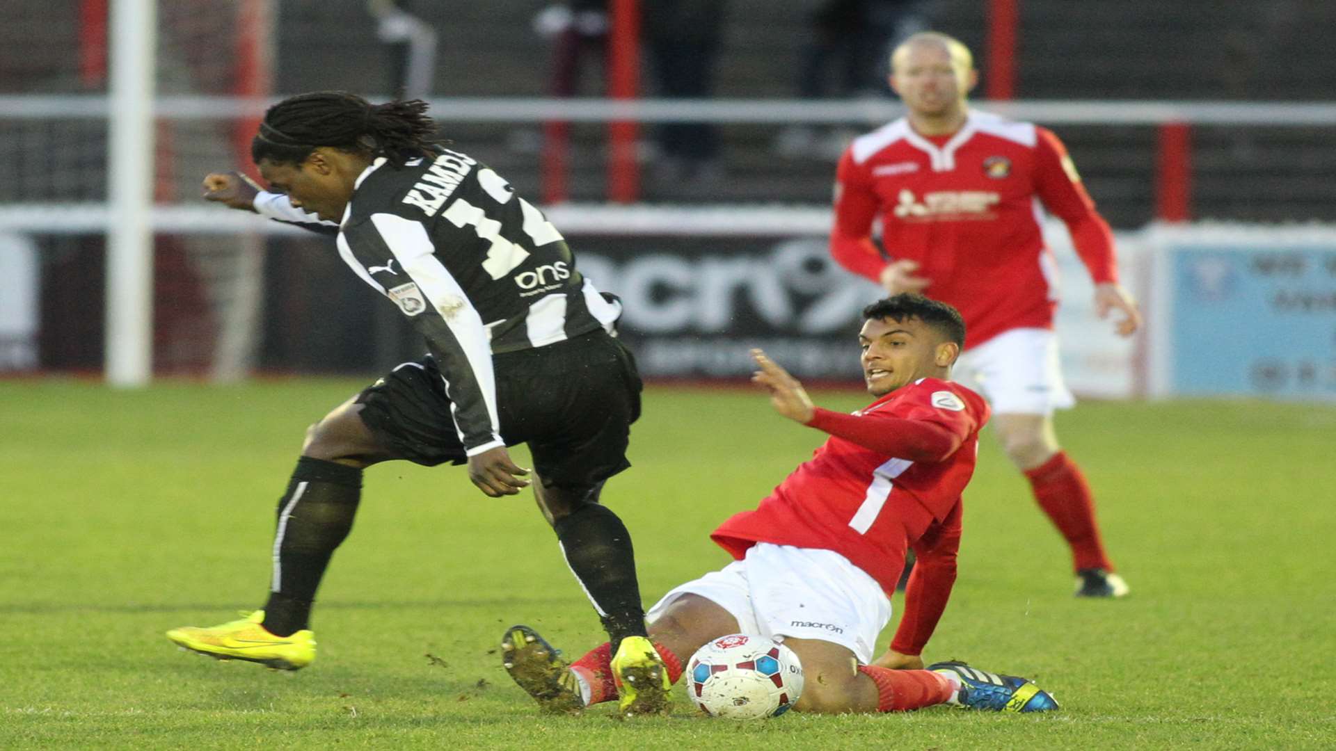 Theo Lewis tackles Forest Green's Clovis Kamdjo on his Ebbsfleet debut Picture: John Westhrop