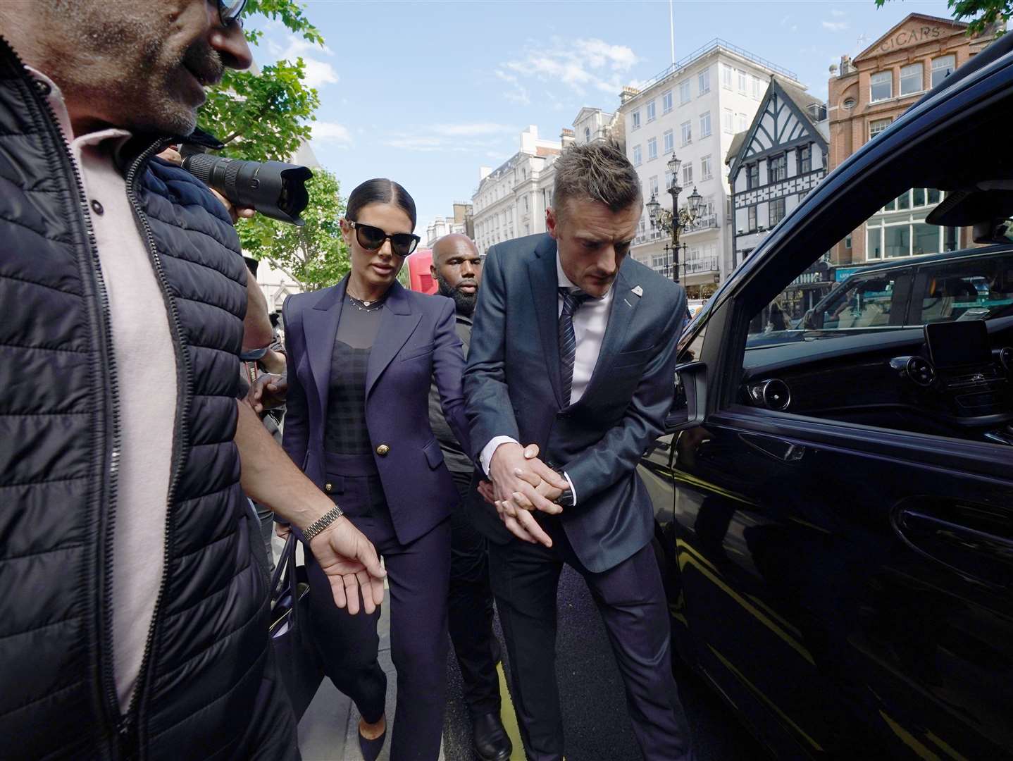 Rebekah and Jamie Vardy leaving court (Yui Mok/PA)