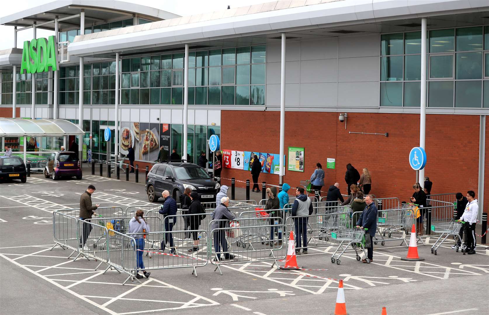 Asda has introduced social distancing at stores (Mike Egerton / PA)