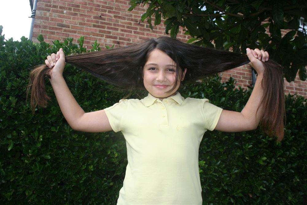 The way it was: Medine Bilgen, 10, shows off her long locks before losing them for charity to The Little Princess Trust.