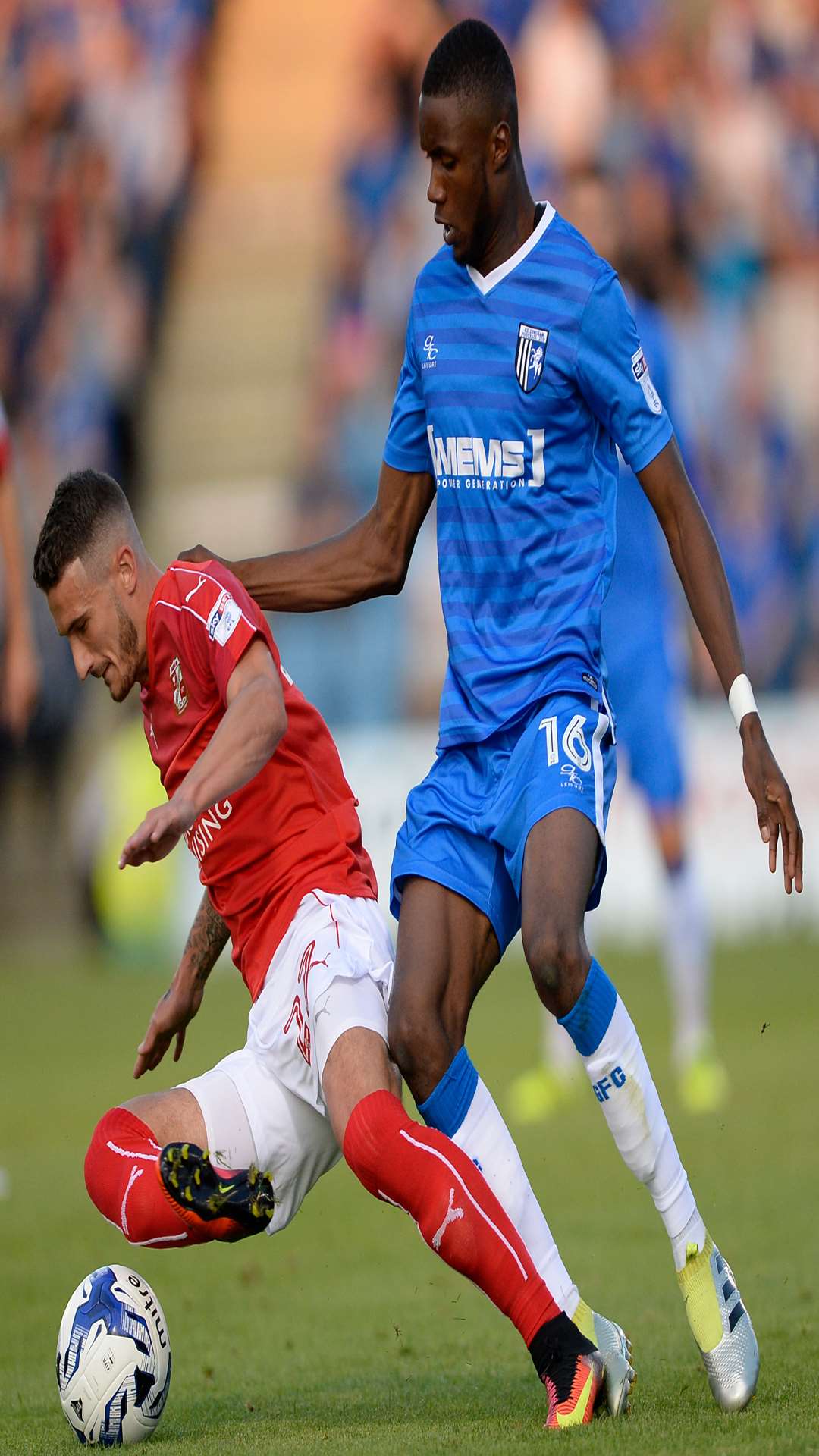 Gillingham's Emmanuel Osadabe challenges Swindon's Bradley Barry. Picture: Ady Kerry