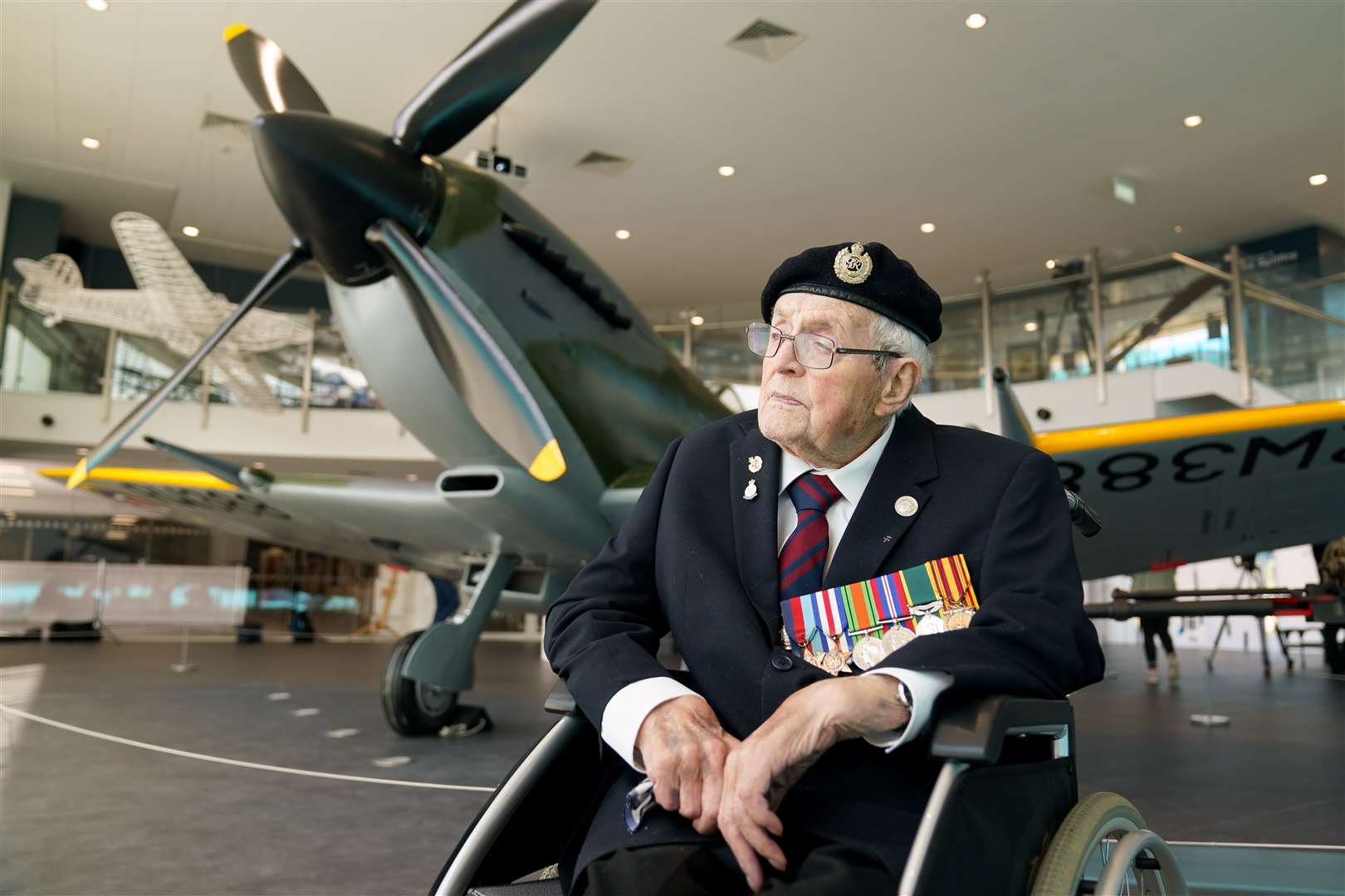 Veteran Norman Lewis, 102, beside the newly restored Spitfire (Jacob King/PA)