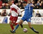 Adam Bygrave puts pressure on Walsall's Troy Deeney. Picture: ANDY PAYTON