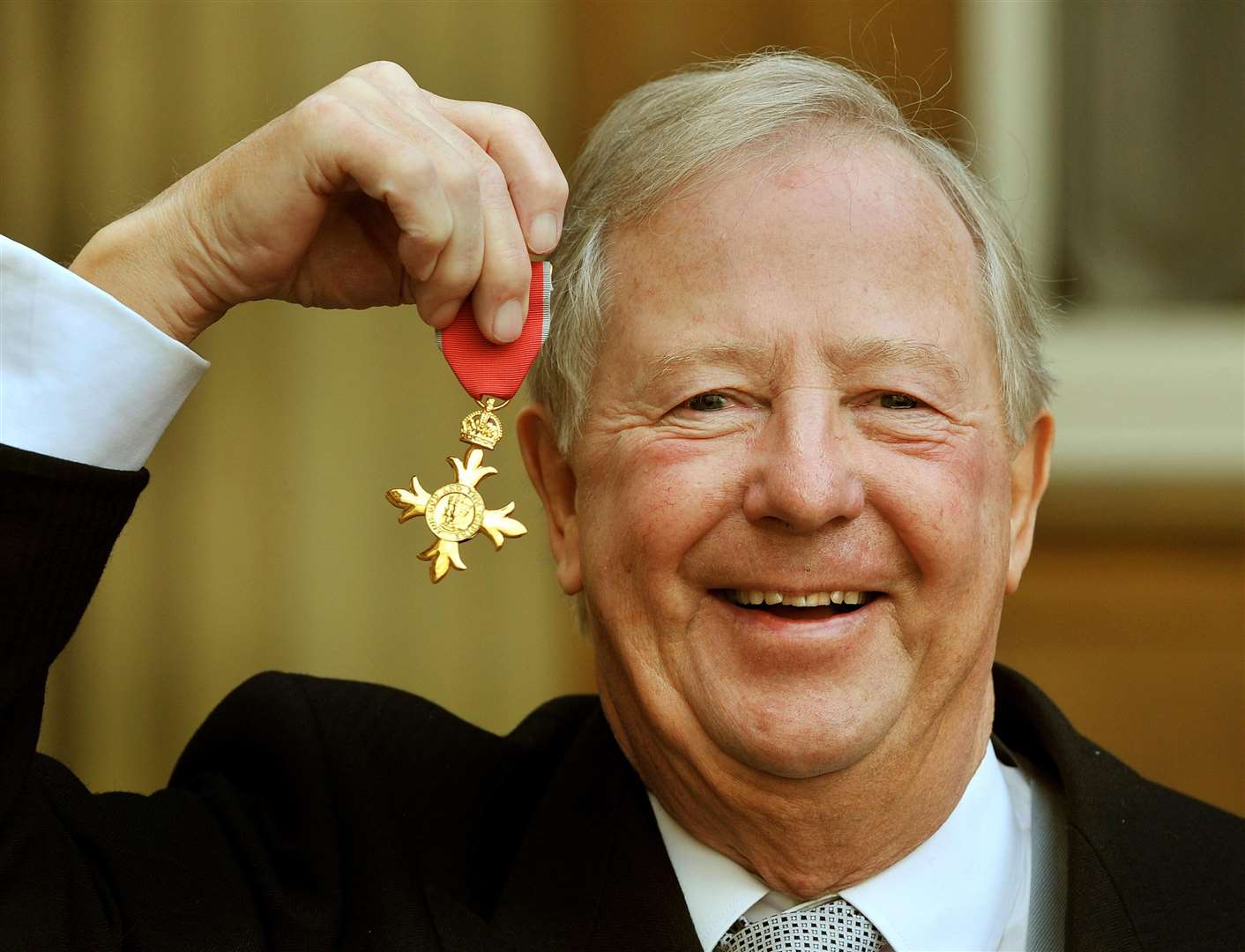 Tim Brooke-Taylor holding his OBE ion 2011 (PA)