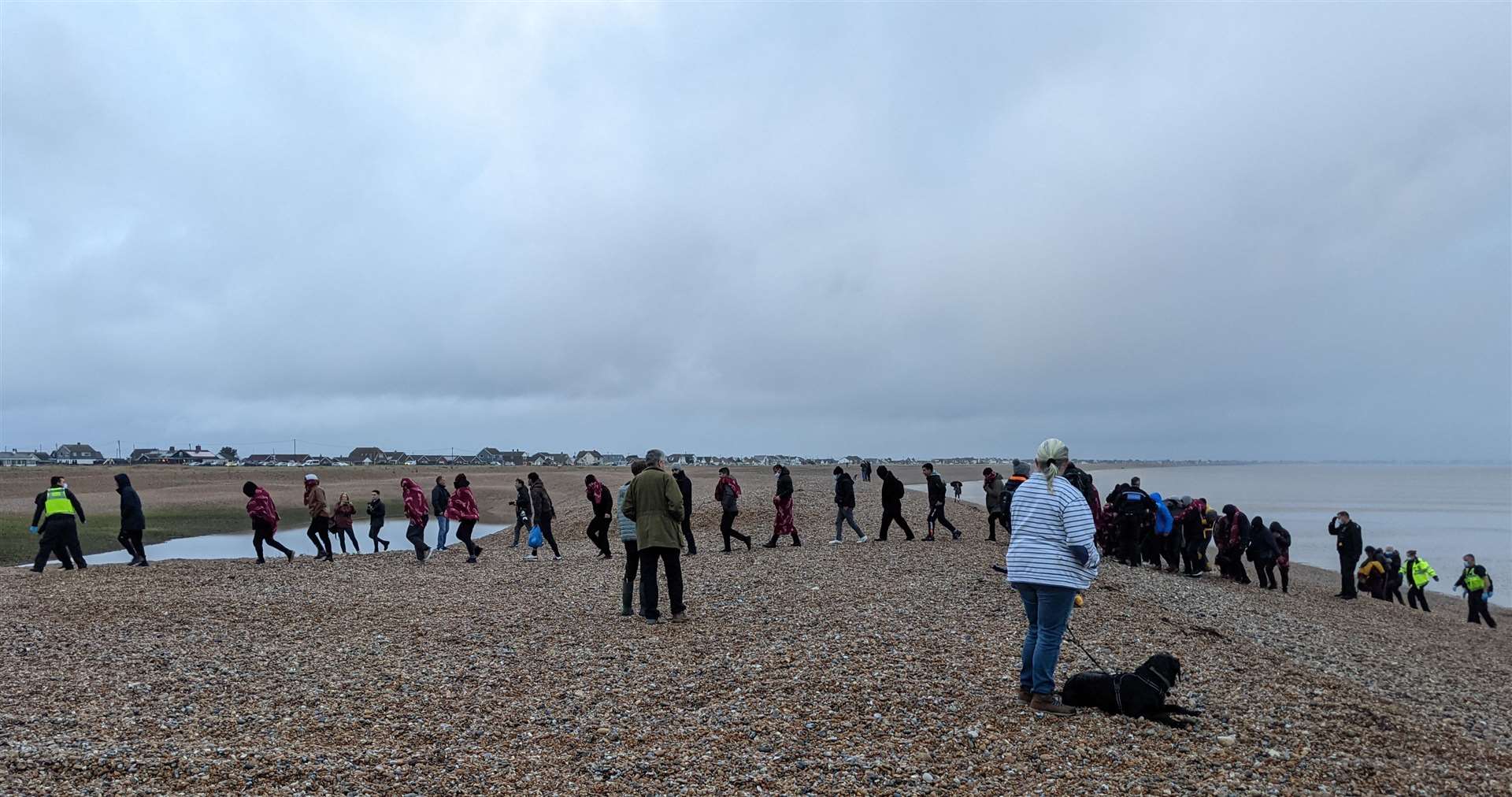 People being escorted from the beach by police at Dungeness on Saturday. Picture: Paul Fenney