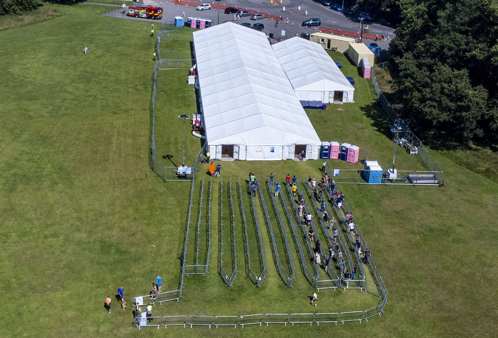 People begin queuing at an NHS pop-up vaccination centre at Sefton Park in Liverpool (Peter Byrne/PA)