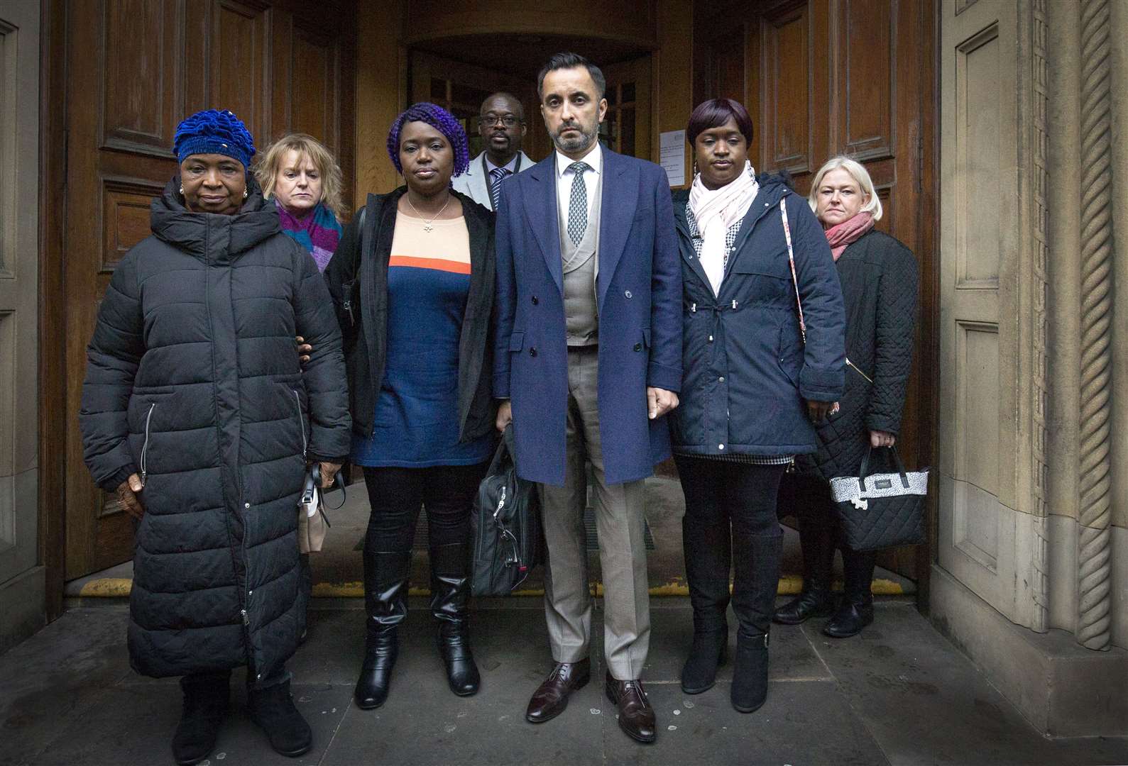 Solicitor Aamer Anwar, centre, with members of Sheku Bayoh’s family (Jane Barlow/PA)