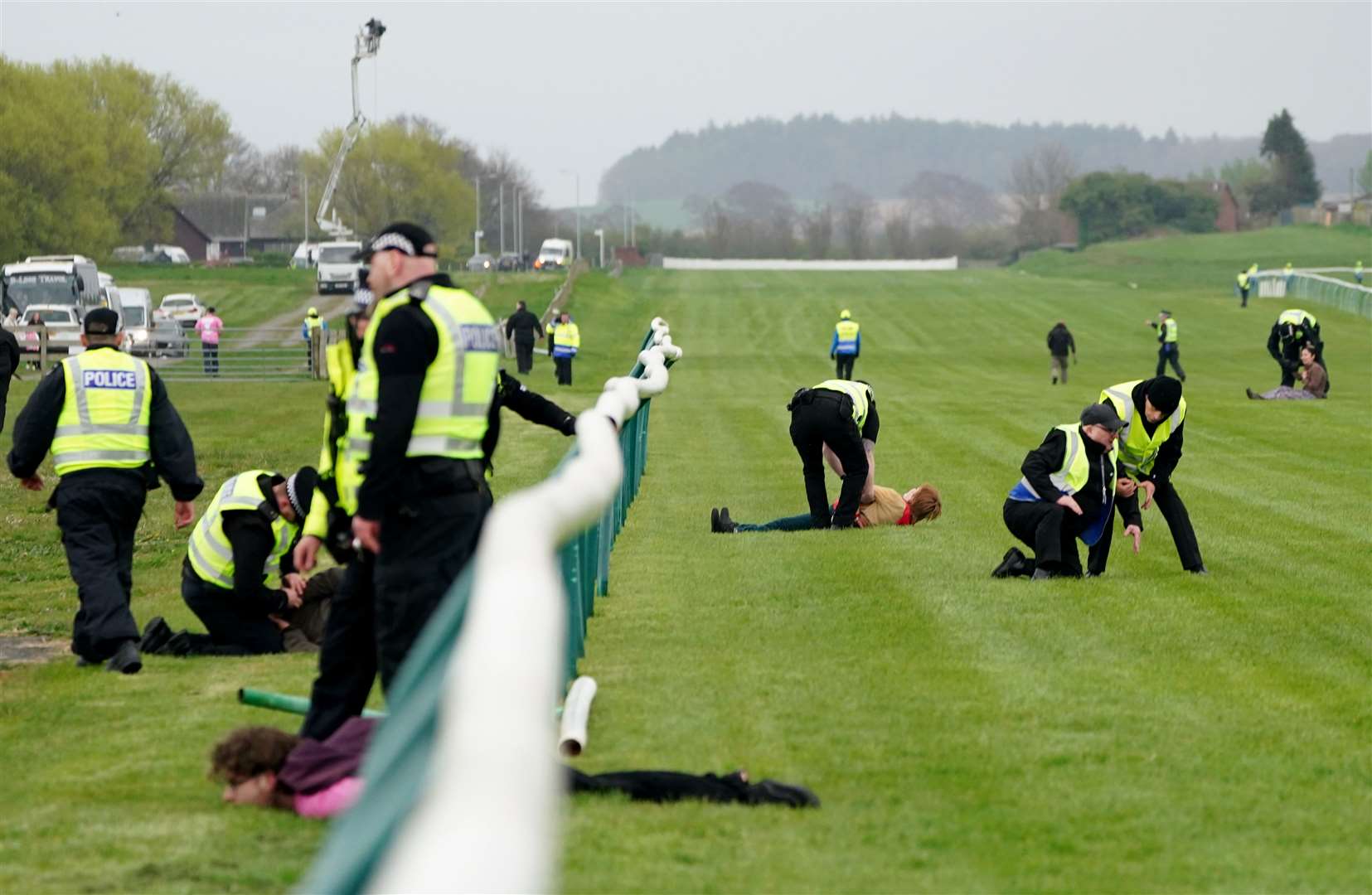 Animal Rising activists were apprehended by police officers as they attempted to invade the racecourse (Jane Barlow/PA)