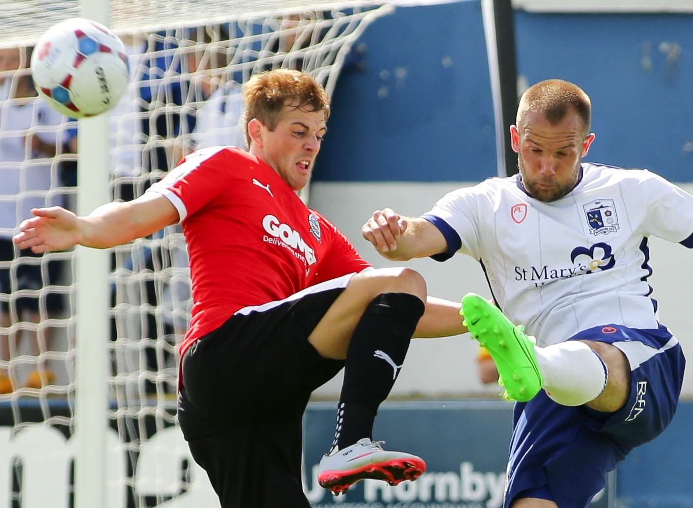 Tom Murphy,left, in action during the defeat at Barrow AFC on Saturday Picture: North West Evening Mail