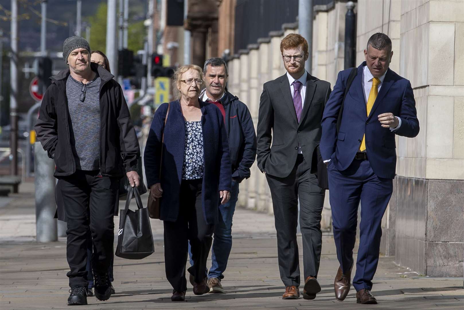 Joe McCann’s widow Anne (centre) and family with their solicitor Niall Murphy (right) arriving to Laganside Court in Belfast (Liam McBurney/PA)