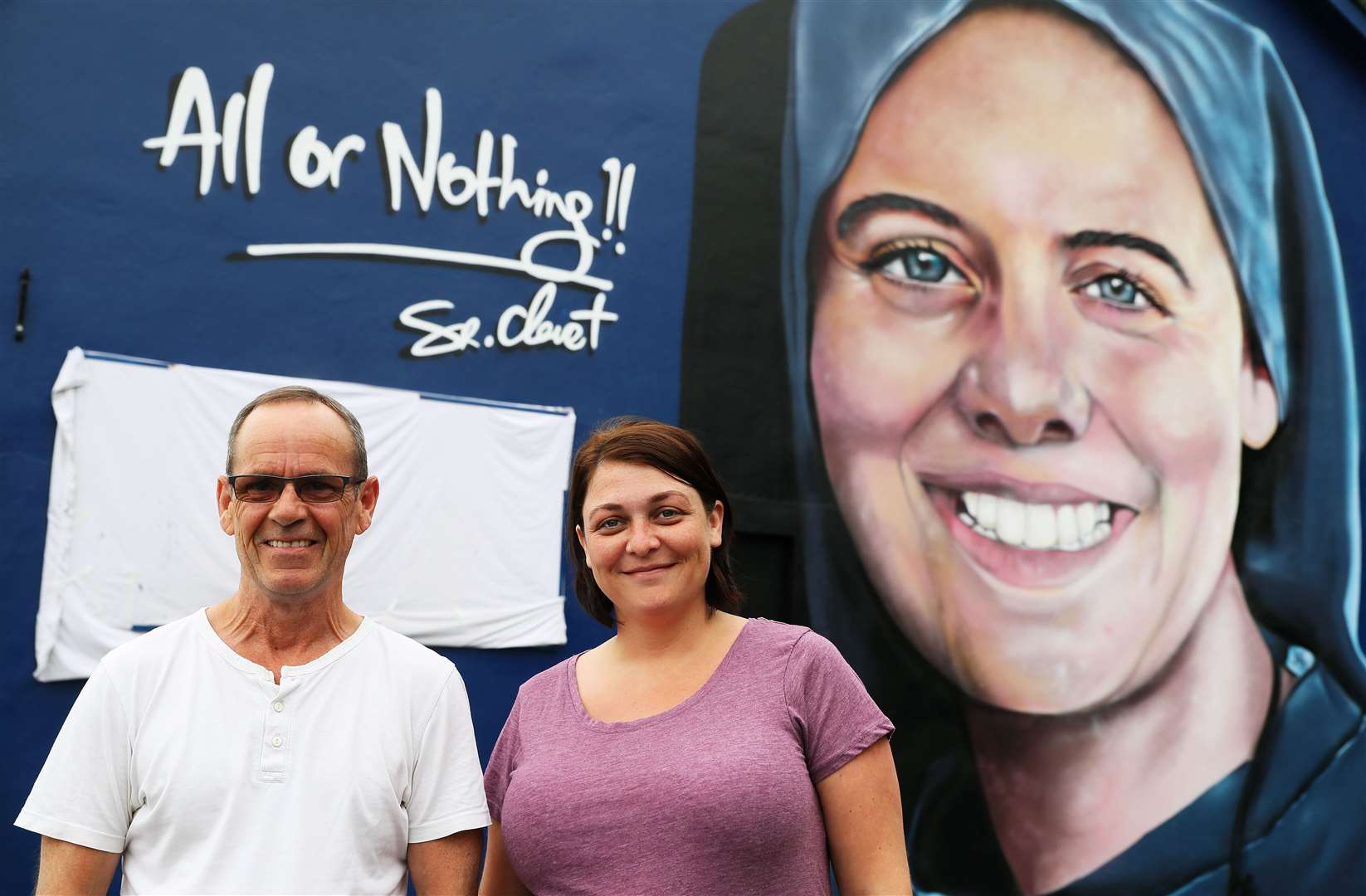 Sister Megan Nicell and Danny Doyle, godfather and uncle to the late nun, in front of the new mural (Brian Lawless/PA)