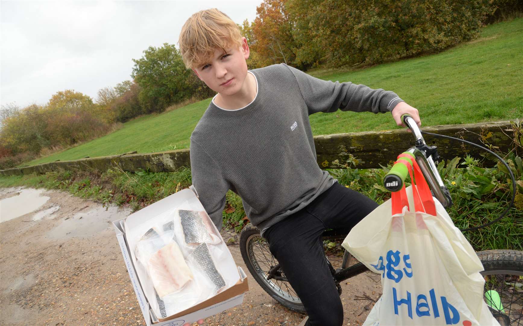 George Theze, aged 16, when he used to deliver fish on his bike. He has now moved onto new heights with a shop in Faversham