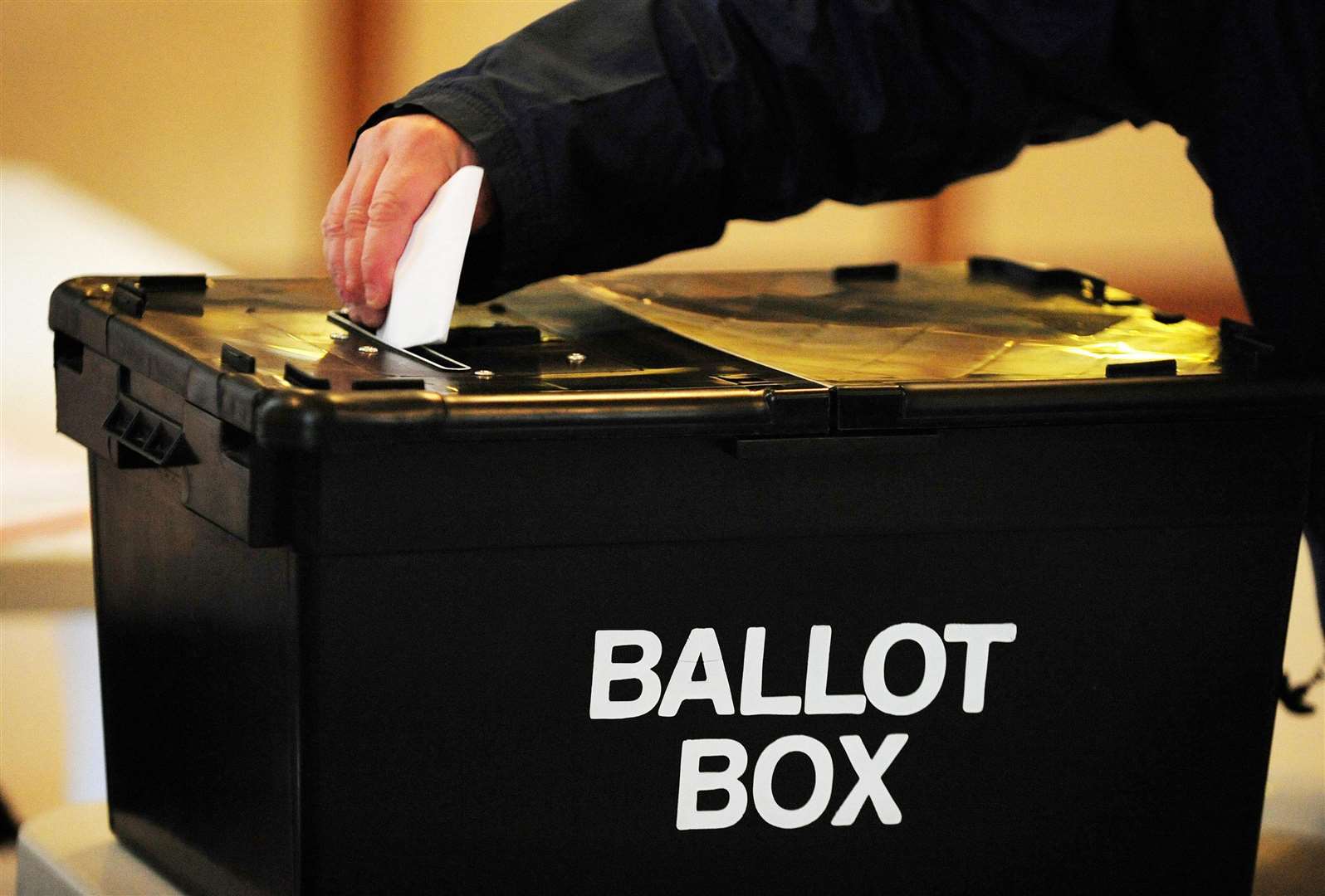 A voter placing a ballot paper in the ballot box. STOCK IMAGE