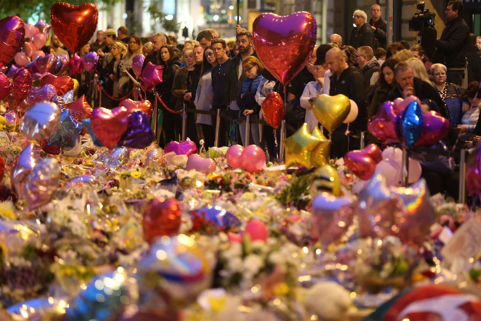 Mourners view tributes in St Ann’s Square, following the Manchester Arena bomb (Jonathan Brady/PA)