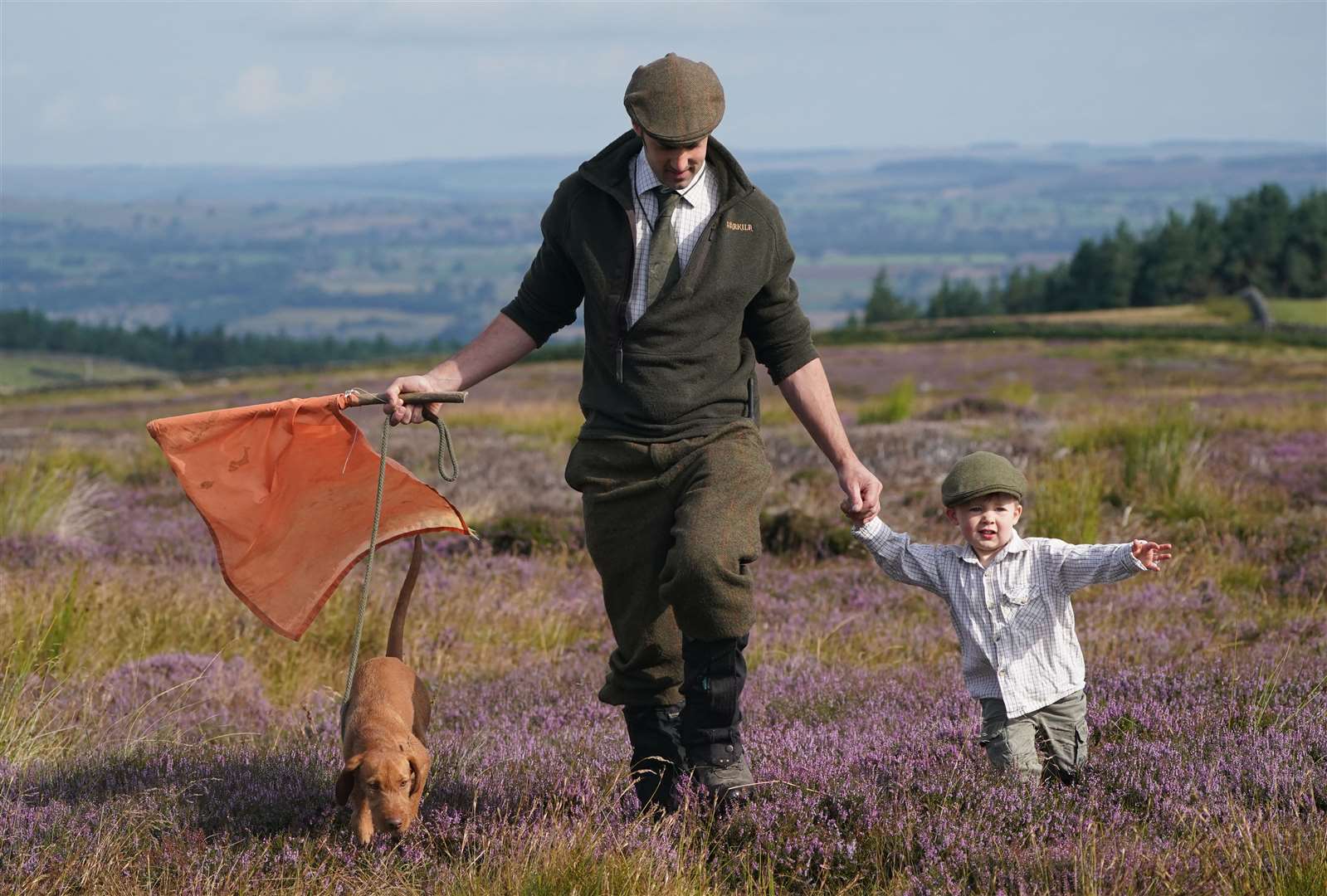 Two-year-old Jack Trufhitt with his father, Graham, 35, from Masham, joins a shooting party on the moors in North Yorkshire (Owen Humphreys/PA)