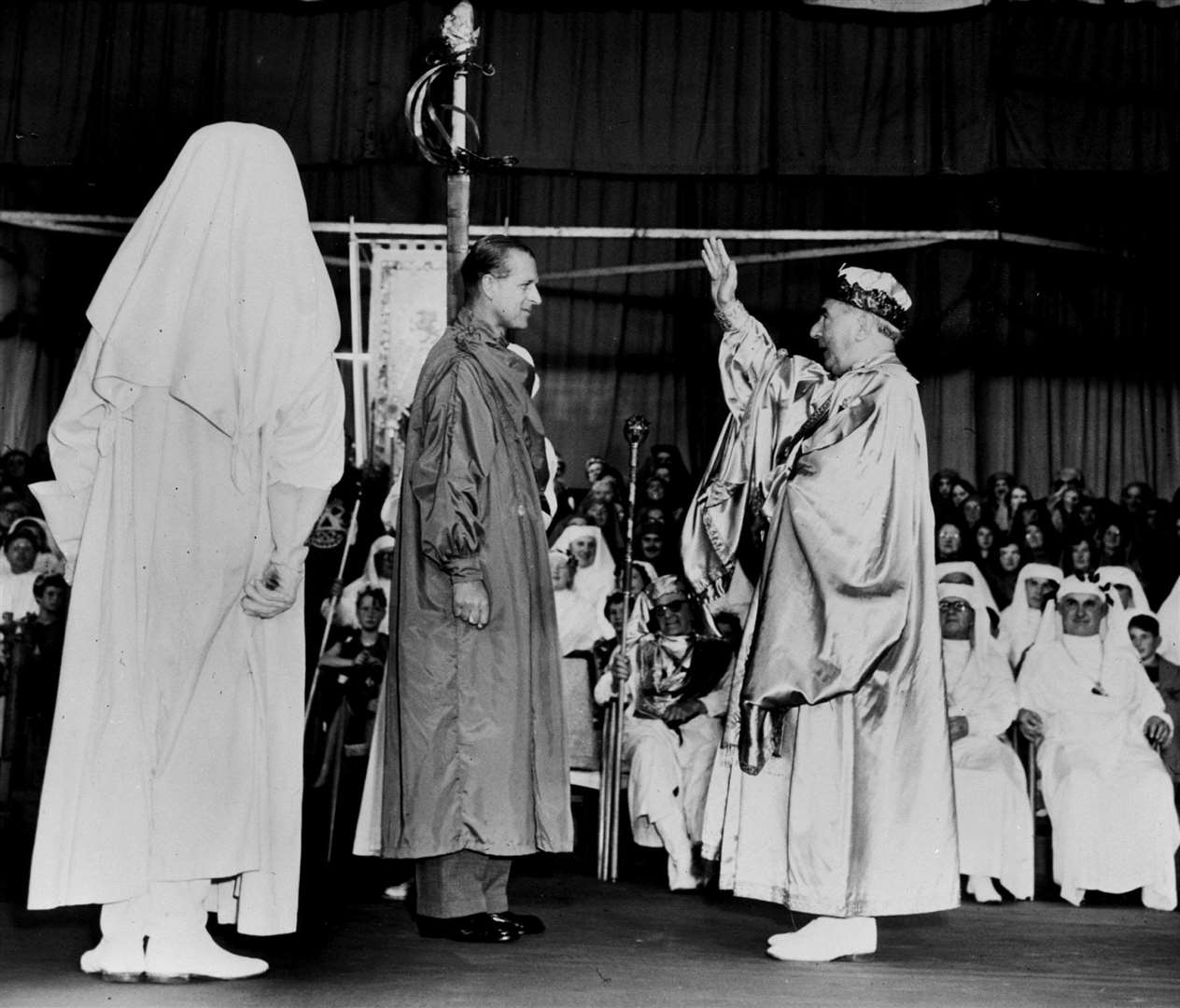 The Duke of Edinburgh, wearing the green robes of a bard, is given his Welsh bardic title ‘Philip Meirionnydd’ by the Archdruid of Wales, Mr Edgar Phillips (right) as he was initiated an Honorary Ovate (graduate) of the Gorsedd of Bards at the National Eisteddfod, at Sophia Gardens, Cardiff (PA)