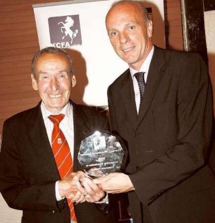 Bruce Smith receives his award for an oustanding contribution to grassroots football from top referee Steve Bennett