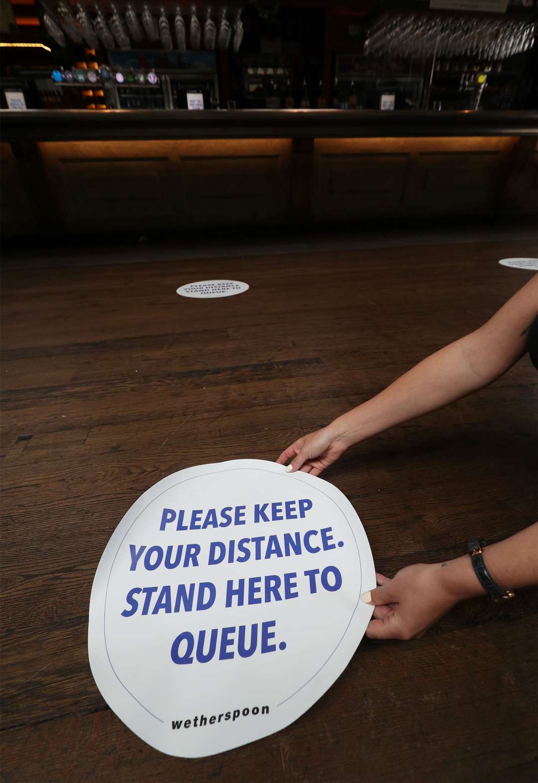 Social distancing signs on the floor of Wetherspoons pub The Mossy Well in Muswell Hill, London (Yui Mok/PA)