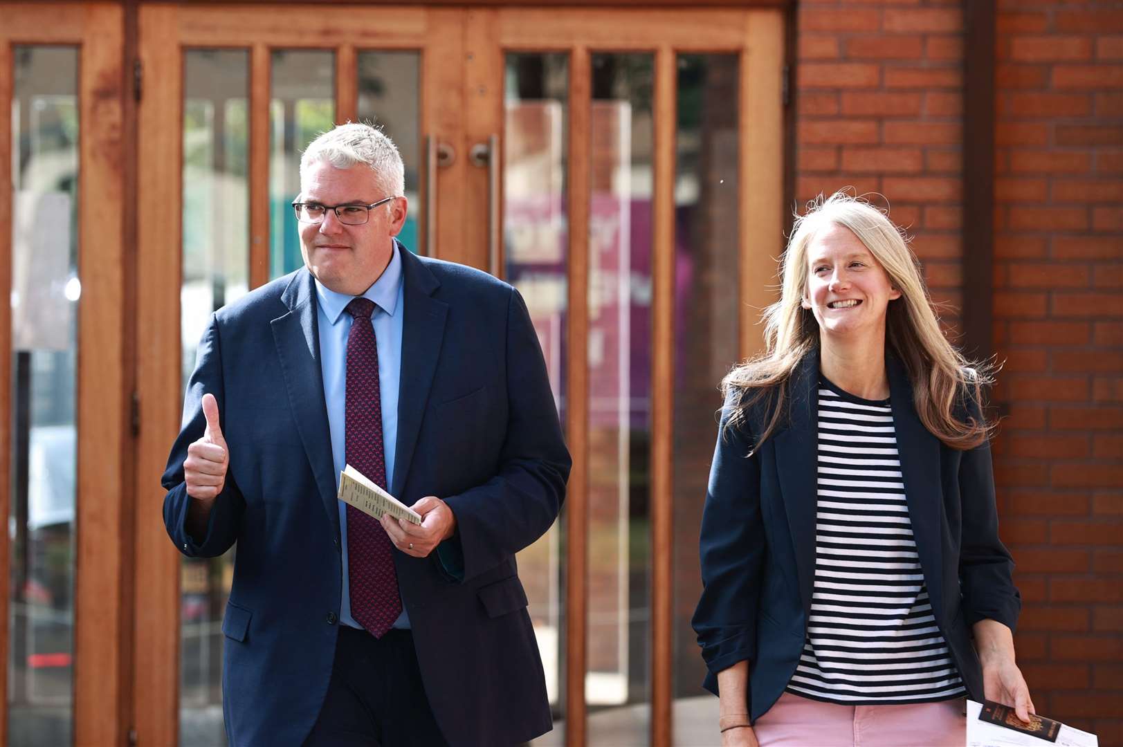 DUP leader Gavin Robinson and his wife Lindsay leave after casting their votes at Dundonald Elim Church in Belfast (Liam McBurney/PA)