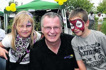 Johnny Lewis of kmfm with Rebecca and Ryan Smith