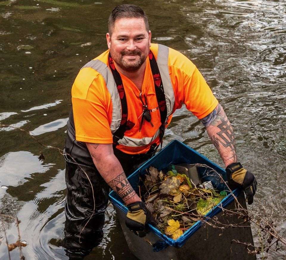 Canenco crew member Chris Murphy removing the bins from the river. Picture: Sian Pettman/Canterbury City Council