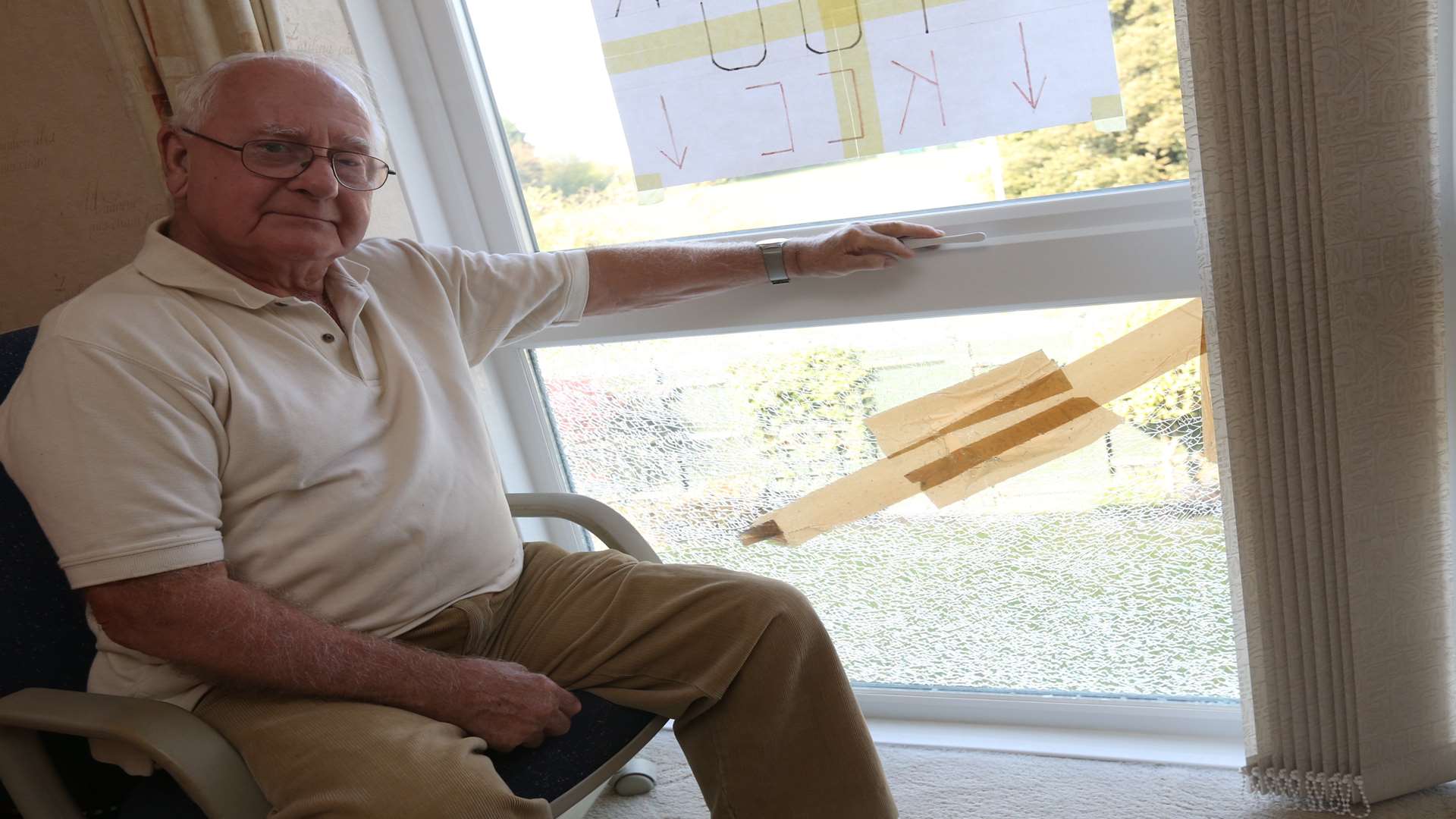 A broken window in his house from a stone thrown from the roadside.