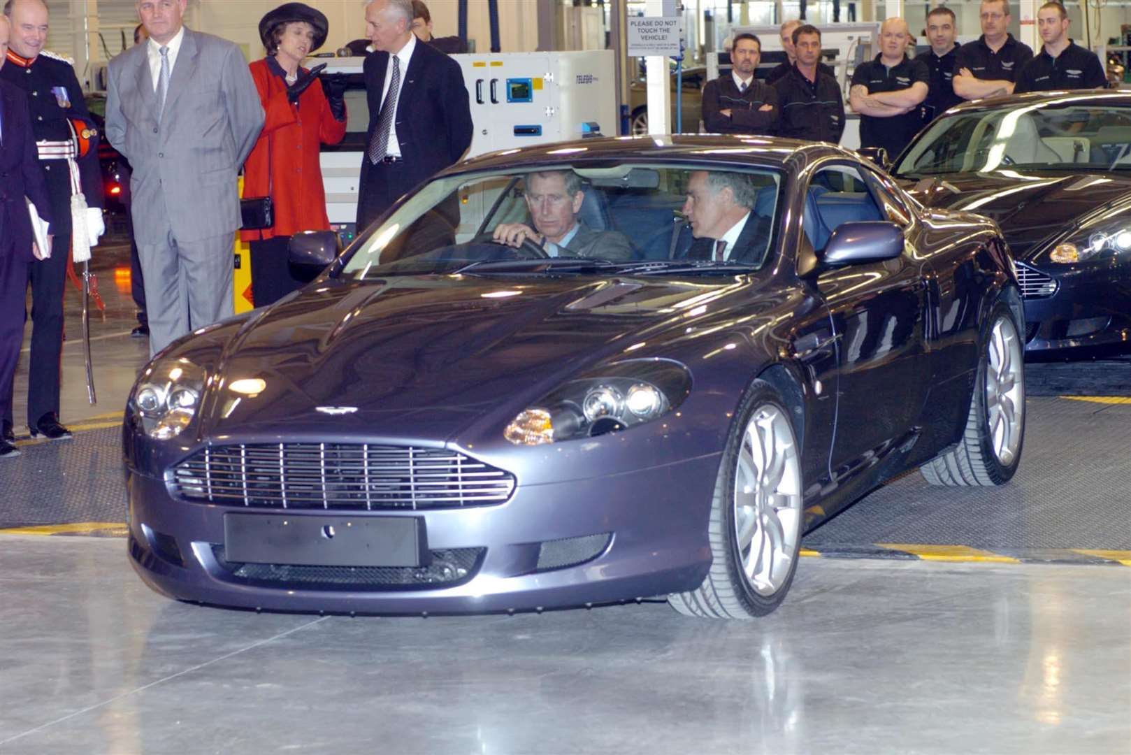 Charles at the wheel of an Aston Martin DB9 (PA)