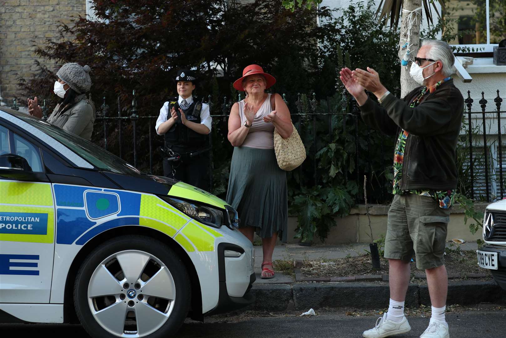 Residents clap in the north London street where Prime Minister Boris Johnson’s top aide Dominic Cummings lives (Yui Mok/PA)