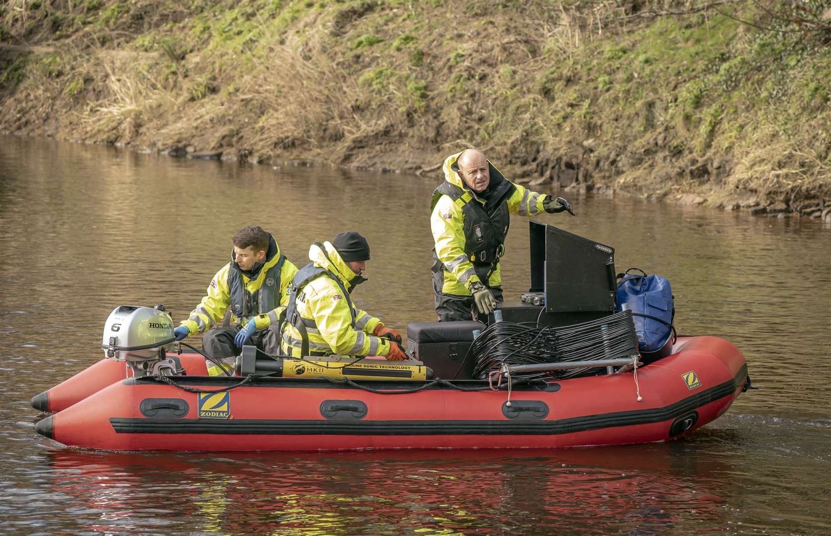 Workers from Specialist Group International on the River Wyre, near St Michael’s on Wyre, Lancashire, on Monday (Danny Lawson/PA)