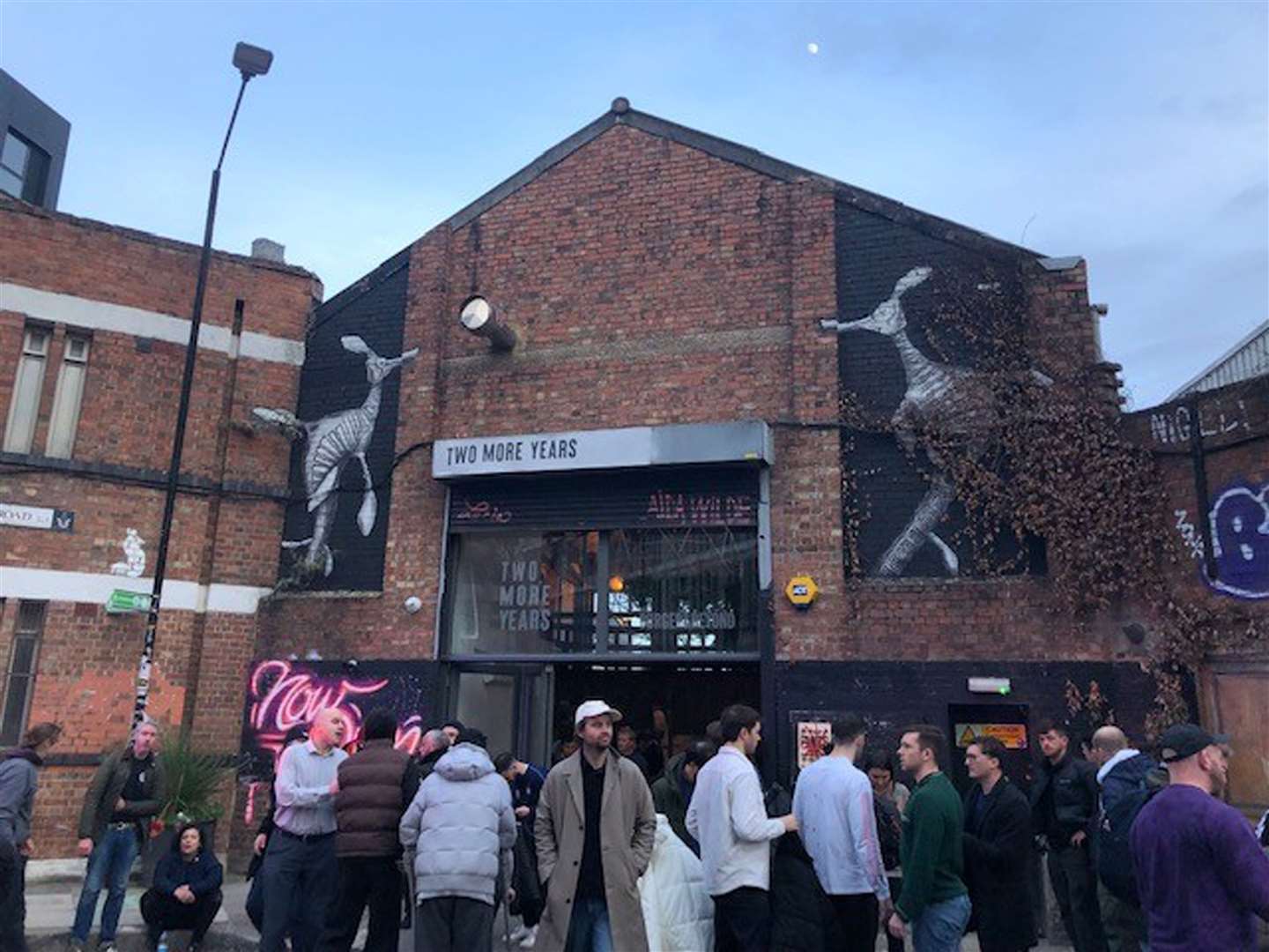 Drinkers gather outside the bar (PA)