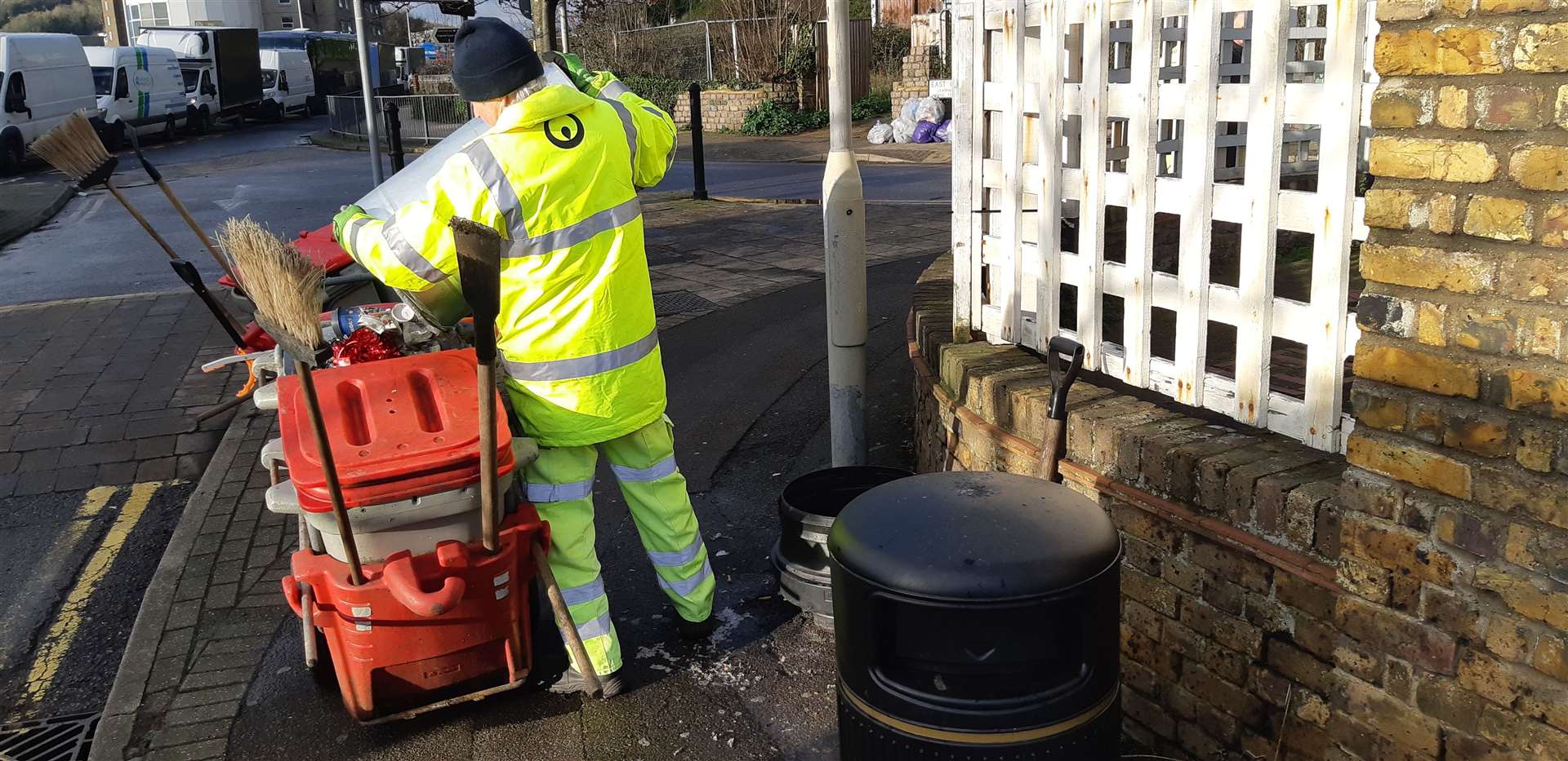 This street cleaner is emptying bins that had spilled over with food wrappers, cans and bottles from the drivers who spent three nights in queues