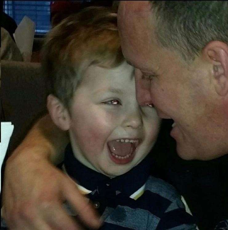 Ollie Jones smiles with his dad Lloyd