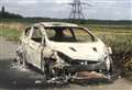 Burnt out car abandoned on country lane