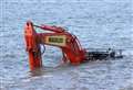 Tractors rescue trapped digger from beach