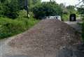 Tipper truck dumps mountain of soil in middle of road