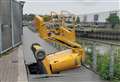 Cherry picker crashes through supermarket bridge